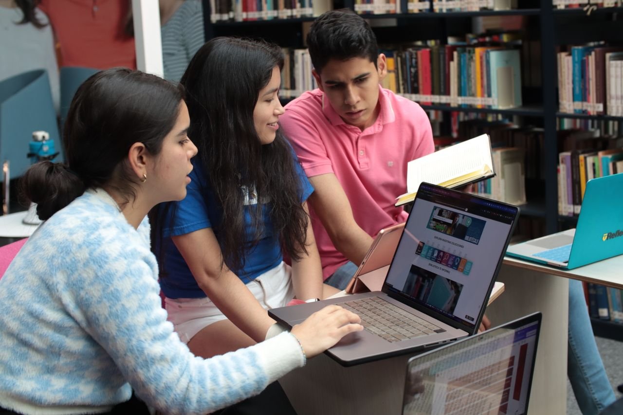 Crafting Captivating Headlines: Your awesome post title goes here Group of young students studying and discussing in a library setting with books and laptops.