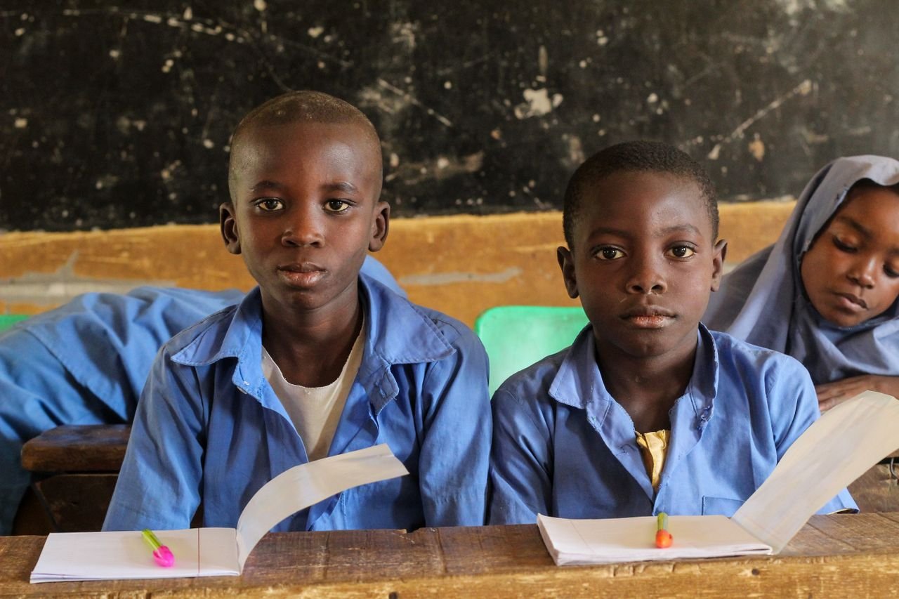 Mastering the First Impression: Your intriguing post title goes here Children in a rural classroom setting focused on their studies, showcasing educational diversity.