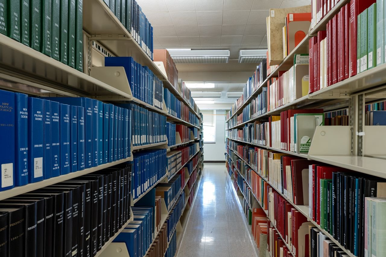 services-04 Wide aisle of bookshelves in an academic library at Washington State University.